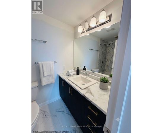 A bathroom with a marble floor and a white sink.