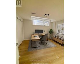 A virtual staged image of a room with a desk and a chair.