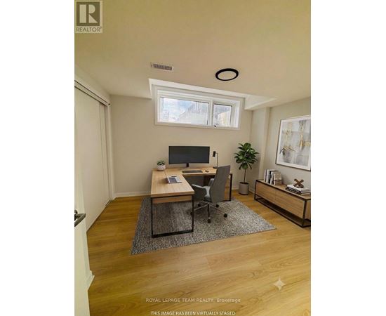 A virtual staged image of a room with a desk and a chair.