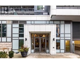 A modern building with a glass entrance and a sign that reads "IQI GLOBAL REAL ESTATE BROKERAGE".