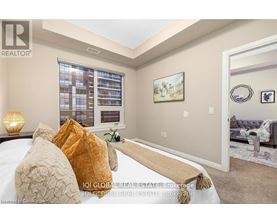 A bedroom with a large bed and a painting on the wall.