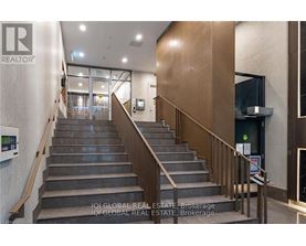 A staircase with a metal railing and a glass door at the top.