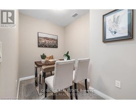 A dining room with a table and chairs.