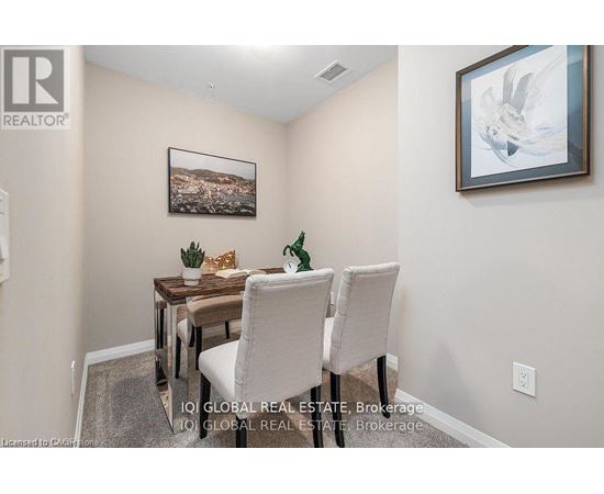 A dining room with a table and chairs.