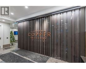 The Corner Club is a modern and sleek establishment with a dark wood panelled wall and a glass door.