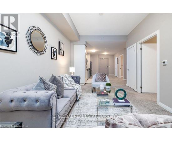 A well-lit, modern living room with a grey sofa and a glass coffee table.