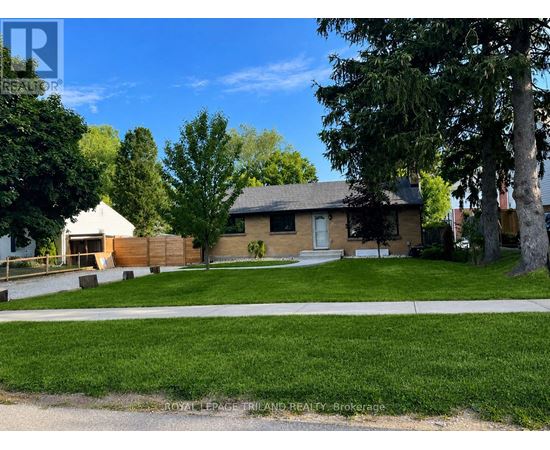 A house with a white picket fence and a green lawn.