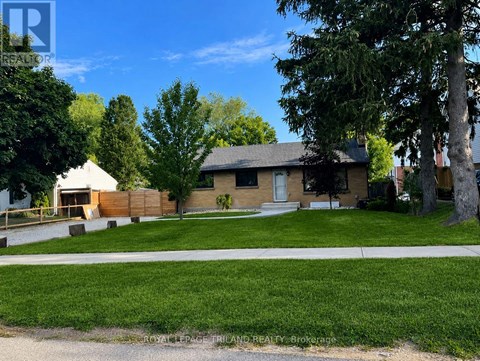 A house with a white picket fence and a green lawn.