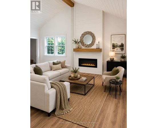 A living room with a fireplace and a white couch.