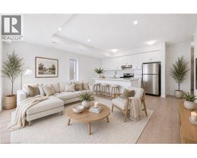 A modern living room with a white sofa, wooden coffee table, and a kitchen in the background.