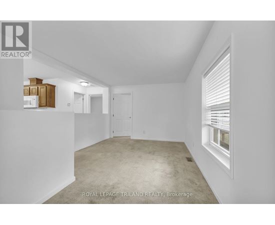 A white room with a window and a door.