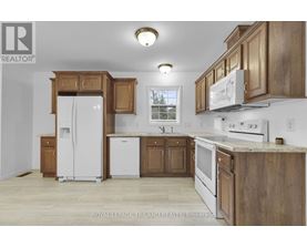 A kitchen with wooden cabinets and white appliances.