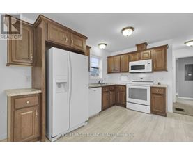 A kitchen with wooden cabinets and white appliances.