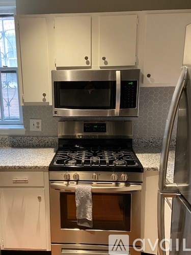 A kitchen with a stove top oven and microwave above it.