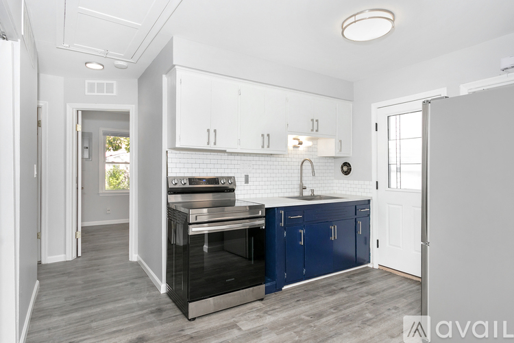 A kitchen with white cabinets and a black oven.