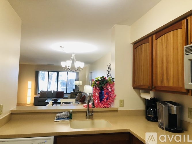 A kitchen with wooden cabinets and a sink.