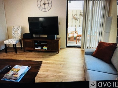 A living room with a television and a chair.