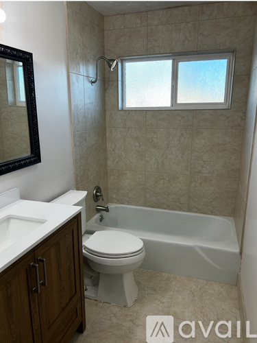 A bathroom with a toilet, sink, and bathtub.