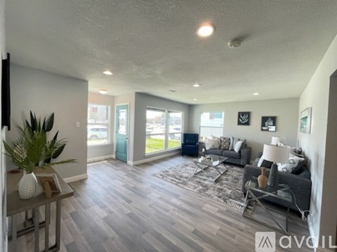 A living room with a grey couch and a wooden coffee table.