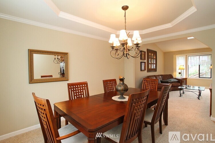A dining room with a wooden table and chairs.