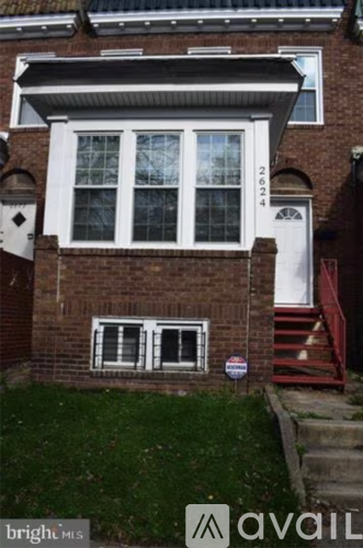 A red brick house with a white door and windows.