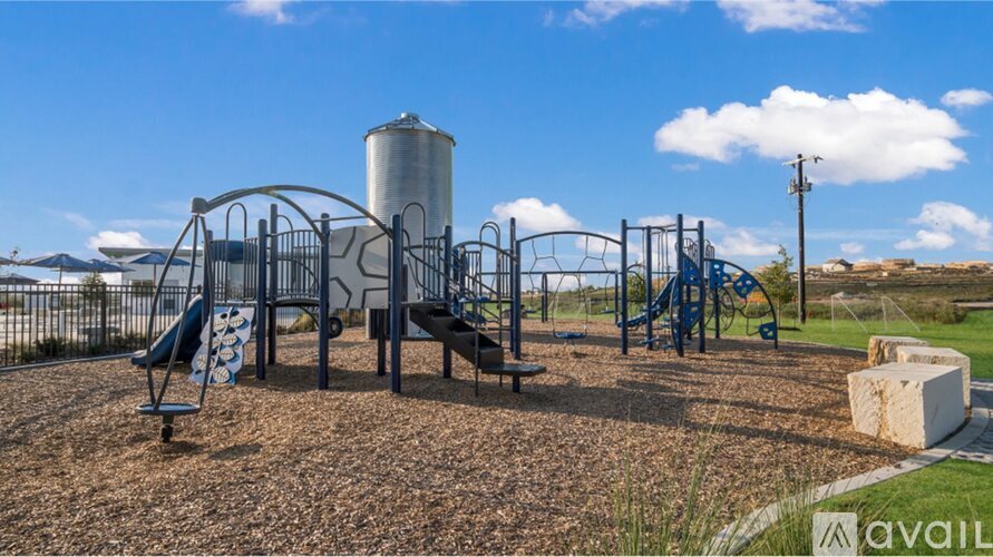 A playground with a slide, swings, and a climbing frame.