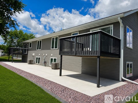 A modern house with a balcony and a gravel pathway.