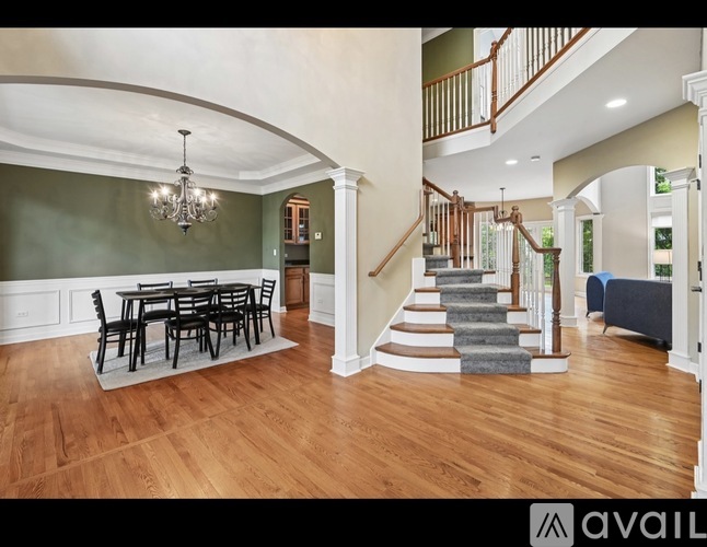 A large open living room with a dining table and chairs.