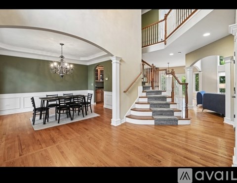 A large open living room with a dining table and chairs.