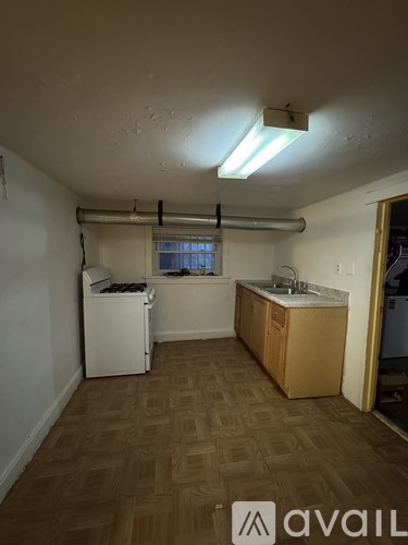 A kitchen area with a sink and a window.