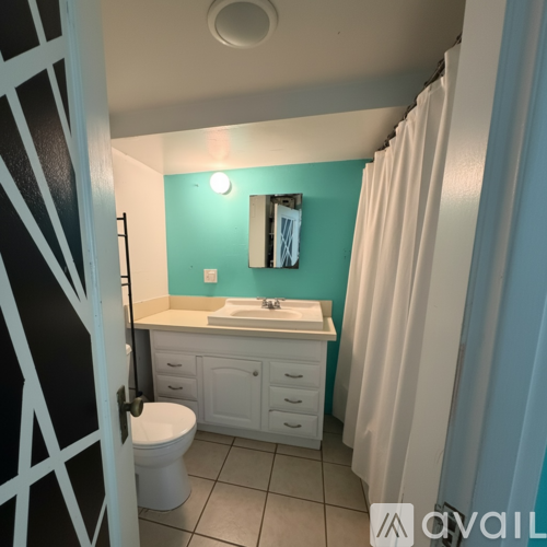 A bathroom with a white sink and toilet.