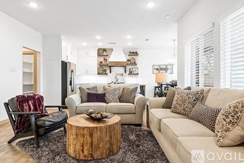 A modern living room with a wooden coffee table and two couches.