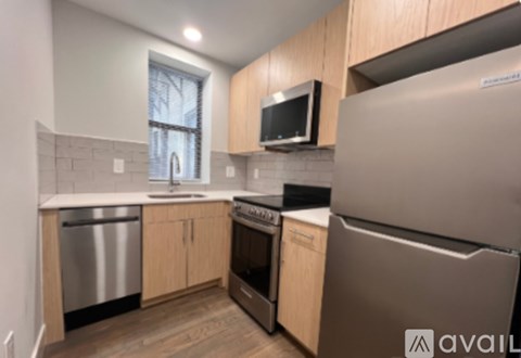 A kitchen with wooden cabinets and stainless steel appliances.