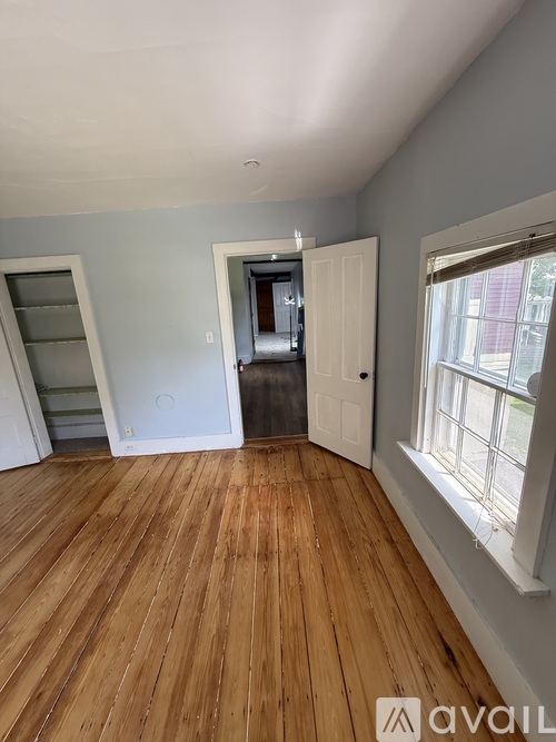A room with wooden floors and a white door.