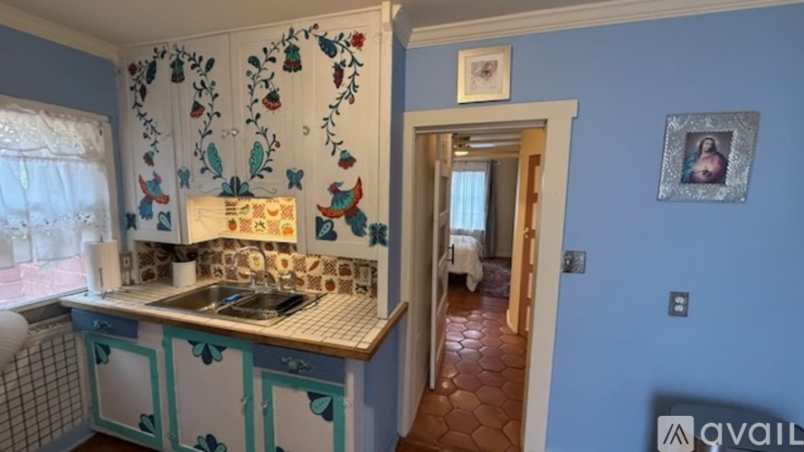 A kitchen with a sink and a window.