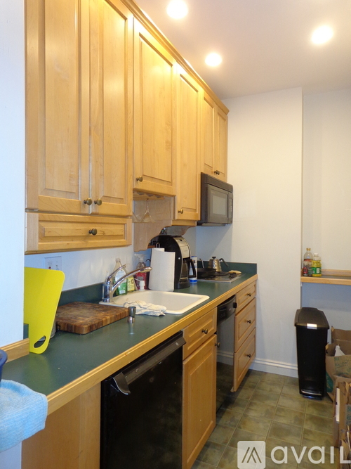A kitchen with wooden cabinets and a green counter top.