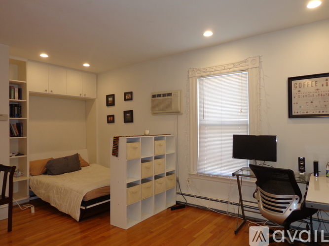 A bedroom with a bed, desk, and chair.