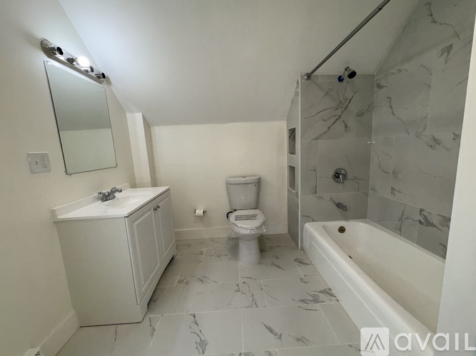 A bathroom with a toilet, sink, and bathtub.