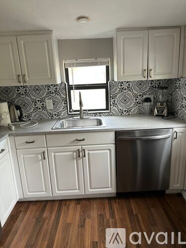 A kitchen with a sink and a window.