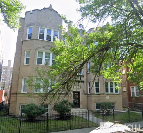 A large building with a black fence in front.