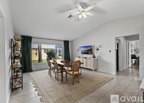 A living room with a dining table and chairs.