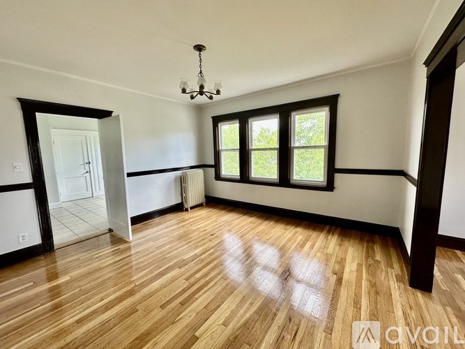 A room with wooden floors and a chandelier.
