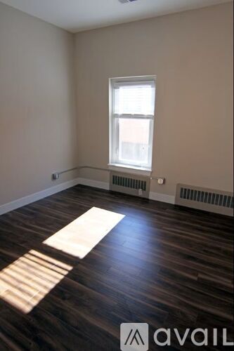 A room with wooden floors and a window.