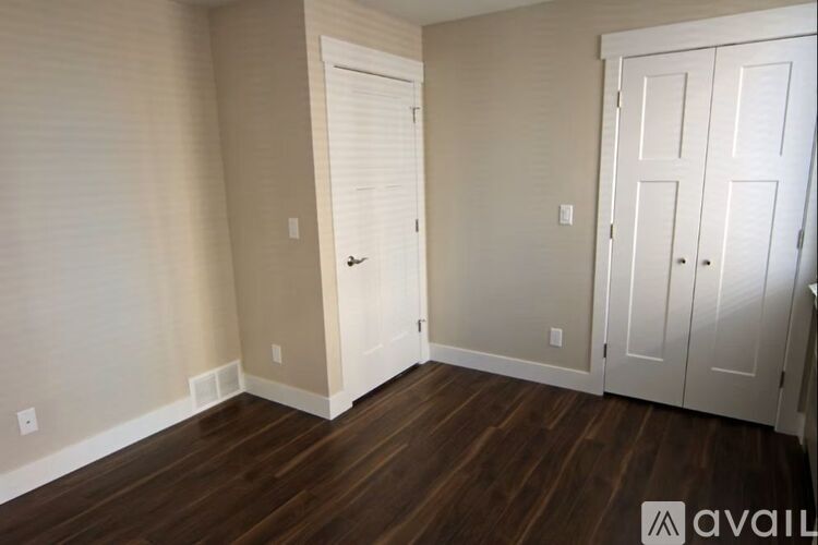 A room with a wooden floor and white walls.