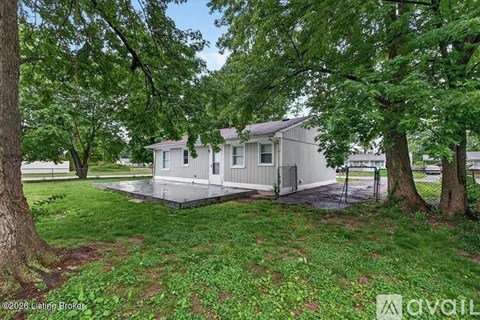 A house is surrounded by trees and grass.