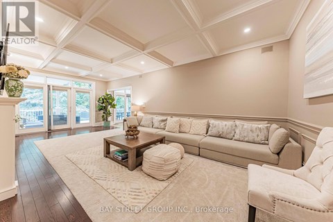 A spacious living room with a large couch and a coffee table.