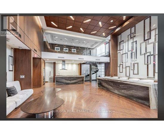 A modern living room with a wooden floor and a large coffee table.
