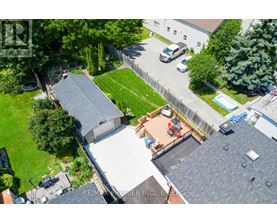 A bird's eye view of a residential area with a house, a car, and a swimming pool.