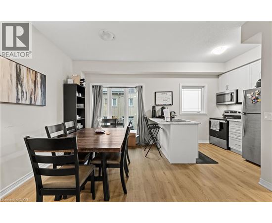 A dining room with a wooden table and chairs is shown.