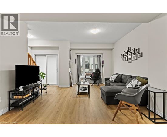 A living room with a black sofa and a television.